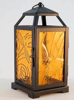 Amber glass set in a Black Lantern with embossed butterflies